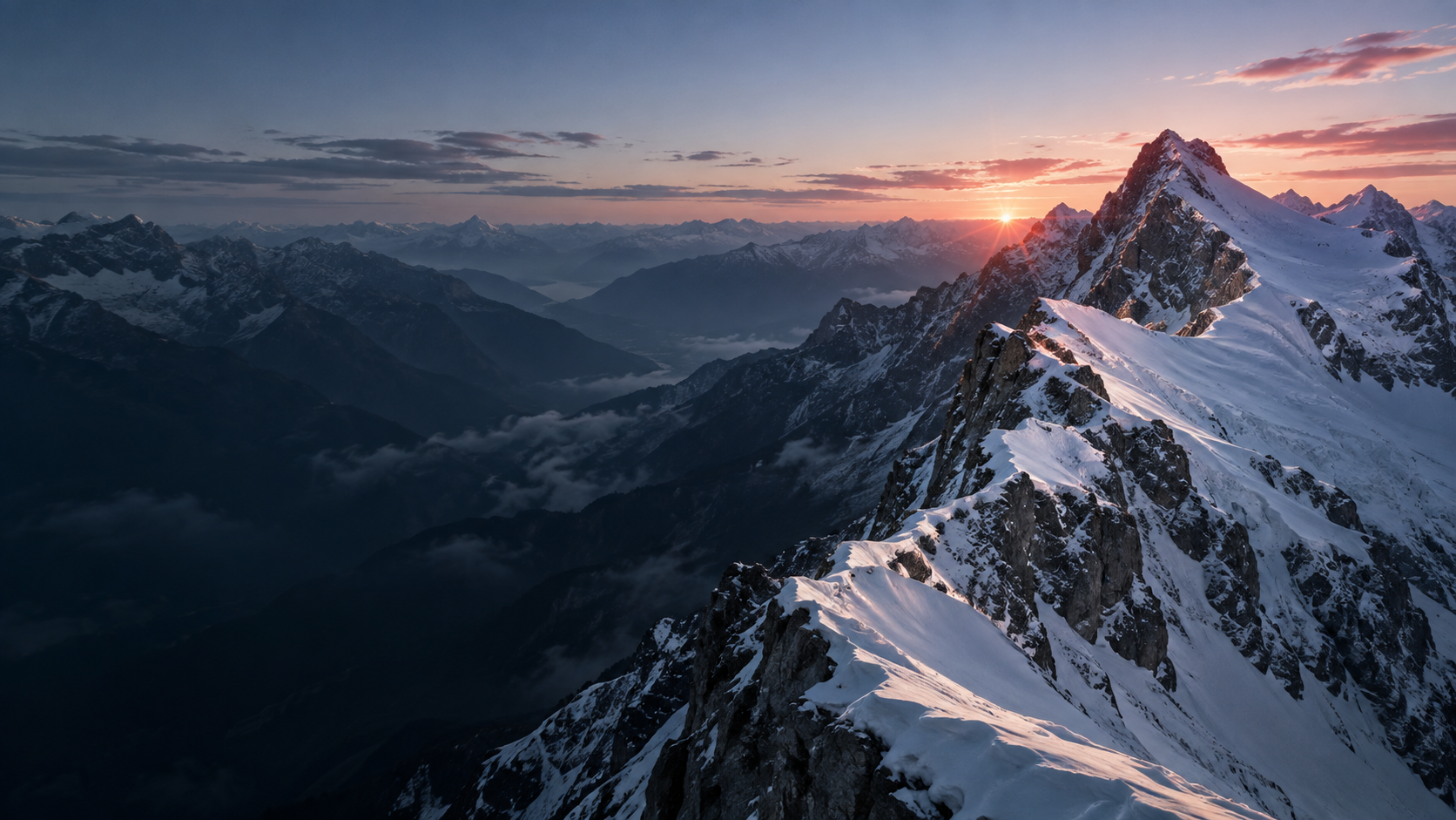 Snow-covered Alpine ridge at sunrise